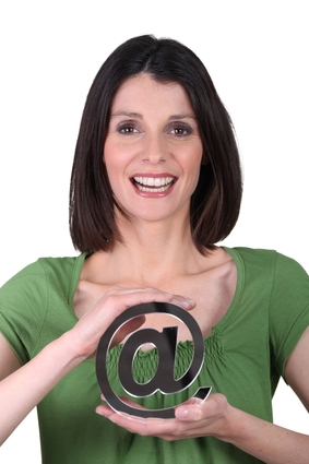 Smiling woman holding the arobase sign